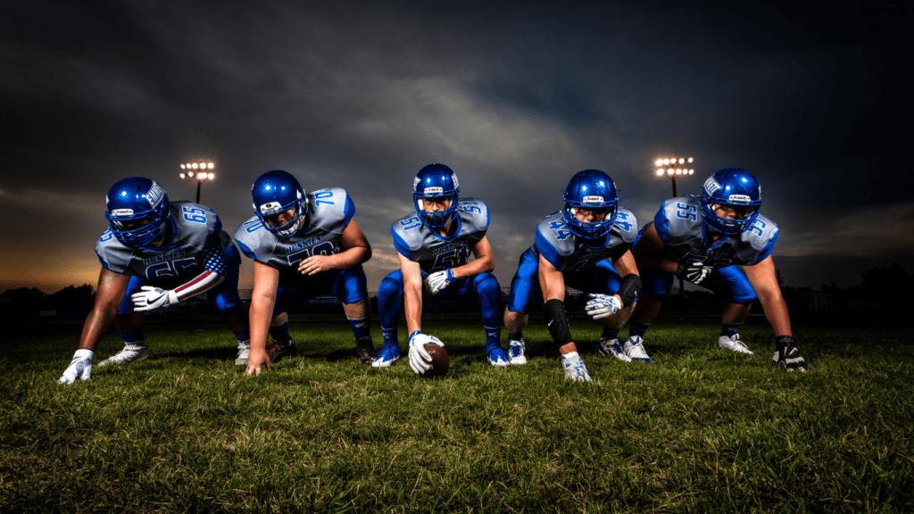 a group of football players are lined up on the field