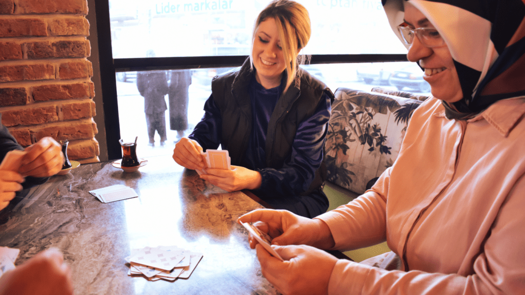 a group of people sitting around a table playing a board game