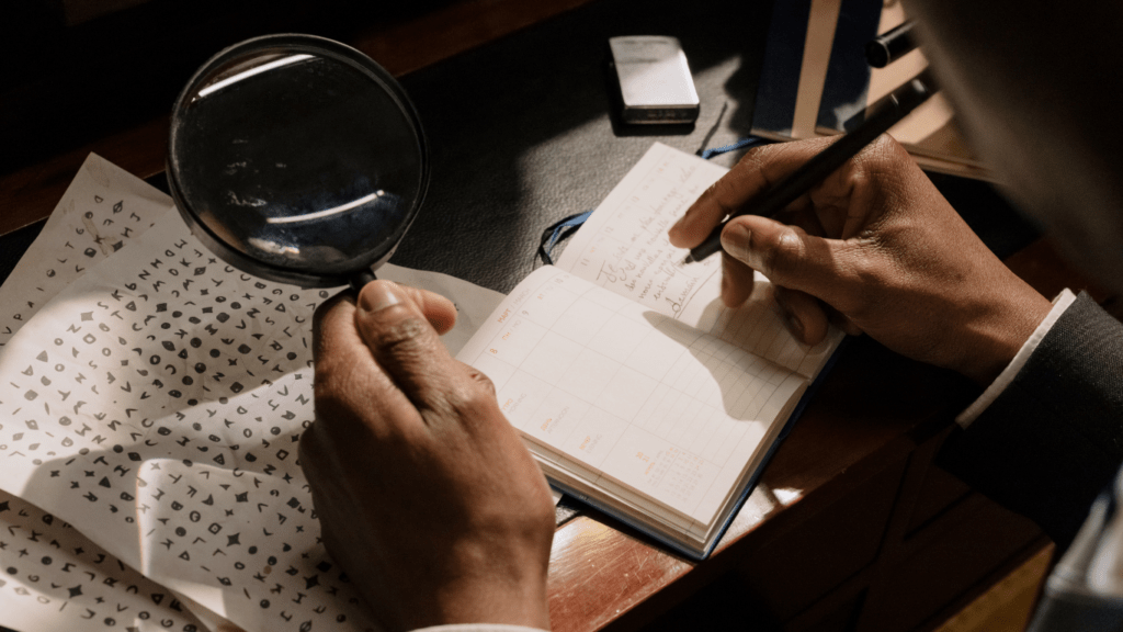 a person in a suit looking through a magnifying glass