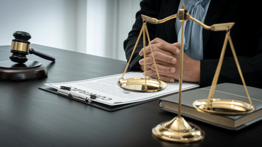 judge's gavel and scales of justice on a table in a courtroom